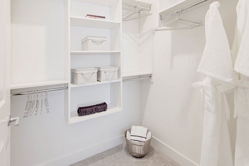 Commercial In-Unit Storage Solutions: Laminate Shelving with Linen Stacks by Innovative Closet Designs 